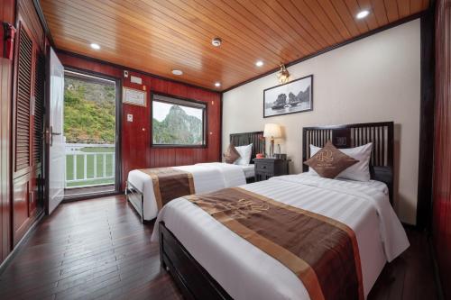 a bedroom with two beds in a room at Ruby Cruise in Ha Long