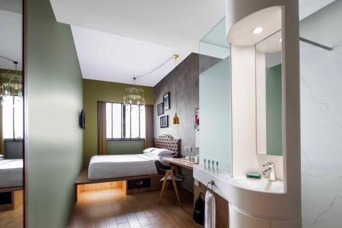 - une chambre avec un lit, un lavabo et un miroir dans l'établissement Hotel Gin Bugis Singapore - previously Hotel G, à Singapour