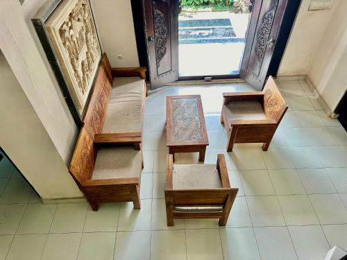 an overhead view of a room with benches on the floor at Bidel's House in Gianyar