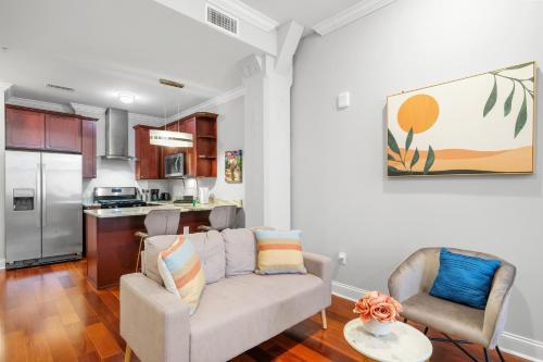 a living room with a couch and a kitchen at XL Studio -Deluxe Studio - Pool & Concierge in Philadelphia