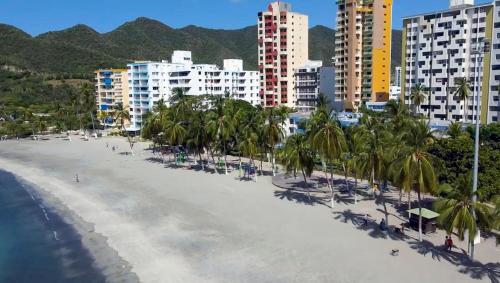 an aerial view of a beach with palm trees and buildings at Apartamento Vista azul RODADERO edificio mara 502 in Gaira