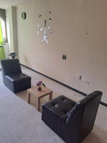 a living room with a couch and a chair and a table at Sientete en casa in Ilo