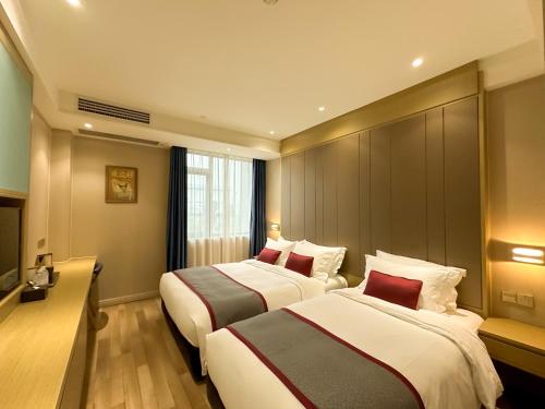 a hotel room with two beds and a window at SHANGHAI-DECO Hotel-Free shuttle bus to Pudong Airport and Disneyland in Shanghai