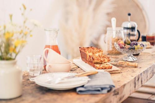 a table with some food on a wooden table at La Nuit & Le Jour in Vertheuil-en-Médoc