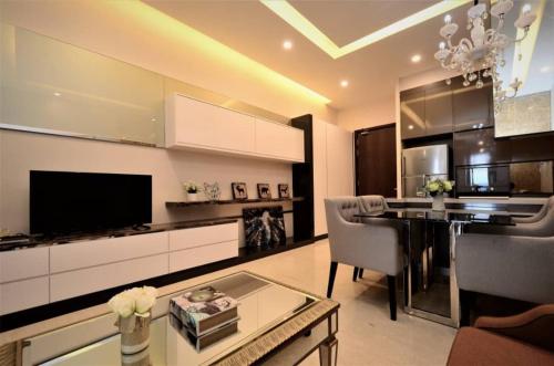 a living room with a dining table and a kitchen at Dorsett Residences Bukit Bintang in Kuala Lumpur