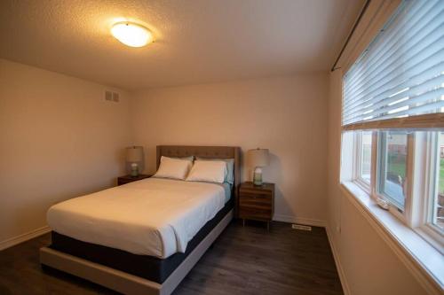 a bedroom with a bed and a window at Designer 3-Bedroom executive townhouse in Grimsby