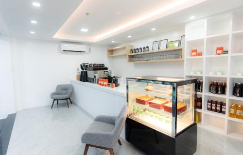 a room with a refrigerator and two chairs at Le Dream Hotel near Vigan in Anomang Mayor
