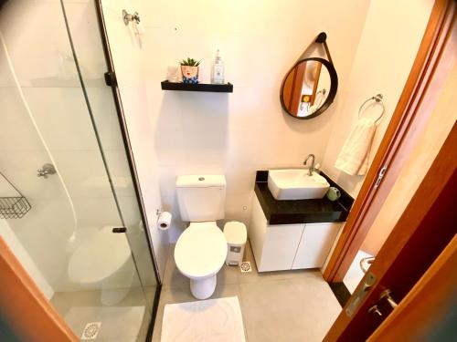 a bathroom with a toilet and a sink and a shower at Flat mais Charmoso da região de Porto de Galinhas in Porto De Galinhas