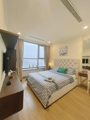 ein Schlafzimmer mit einem großen Bett und einem großen Fenster in der Unterkunft LuxurySunlit/2bed/P10Times in Hanoi