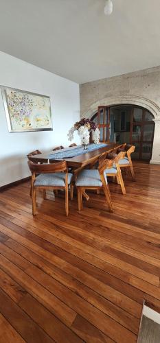 a dining room with a wooden table and chairs at Casa lindavista in Guadalajara