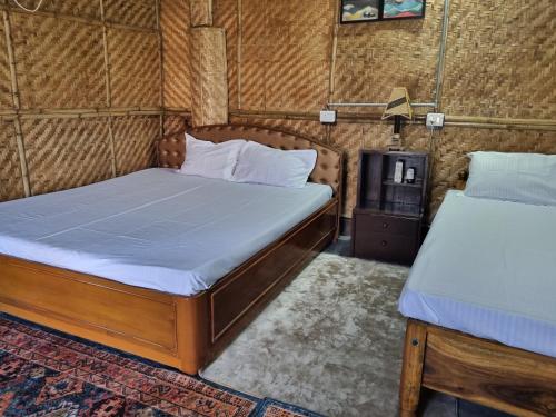 a bedroom with two beds in a room at Alohi The terrace Homestay in Tezpur