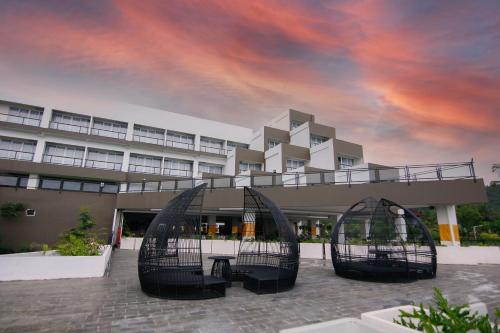 a building with a building with a cloudy sky at Raja Hotel Kuta Mandalika Resort & Convention in Kuta Lombok