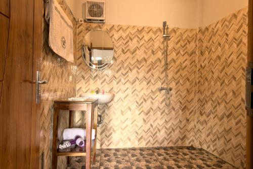 a bathroom with a sink and a shower at Hotel Bonne Nuit in Labuan Bajo