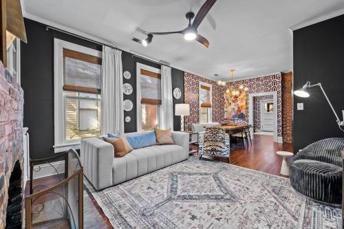 a living room with a couch and a table at Large historical home w/ fire pit, chef kitchen. in Memphis