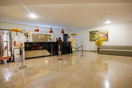a man standing in the middle of a room at Raja Hotel Kuta Mandalika Resort & Convention in Kuta Lombok