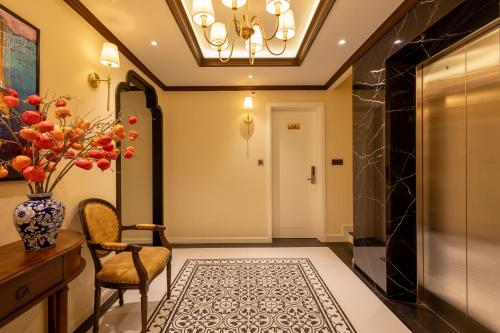 a hallway with a chandelier and a chair at Stella Marina Boutique Hotel in Phu Quoc
