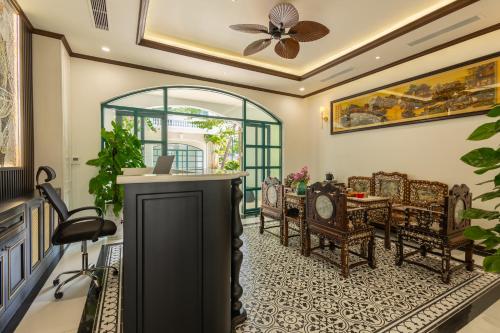 a living room with a table and chairs at Stella Marina Boutique Hotel in Phu Quoc