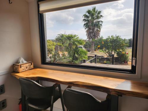 a window in a room with a table and chairs at On the way to Santiago in Seogwipo