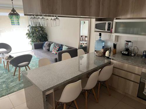 a kitchen and living room with a table and chairs at Quebrada de la Candelaria III in Algarrobo