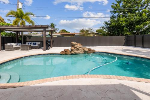 a swimming pool with a rock garden in a yard at Paradise with private pool Sleeps 10 near the beach in Sunrise