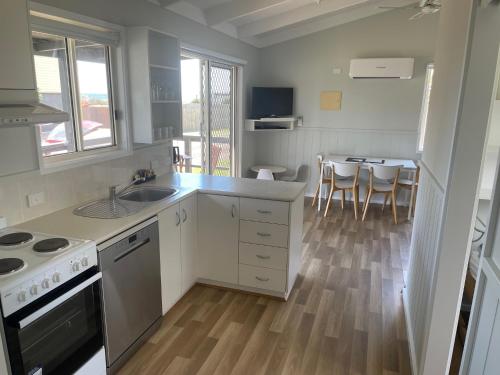 a kitchen with a sink and a stove top oven at Dylene Holiday Park in Portarlington