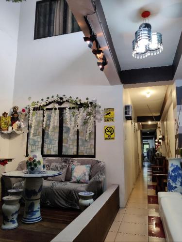 a living room with a couch and a table at Center Parkway Pension House in Kalibo