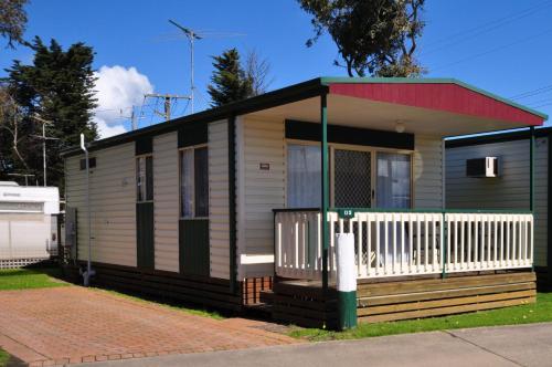 a small house with a red roof at Dylene Holiday Park in Portarlington
