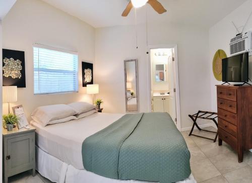 a bedroom with a bed and a flat screen tv at Loft Close to Downtown, Raymond James Stadium, Airport and Many More Places in Tampa
