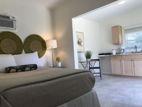 a bedroom with a large bed and a kitchen at Loft Close to Downtown, Raymond James Stadium, Airport and Many More Places in Tampa