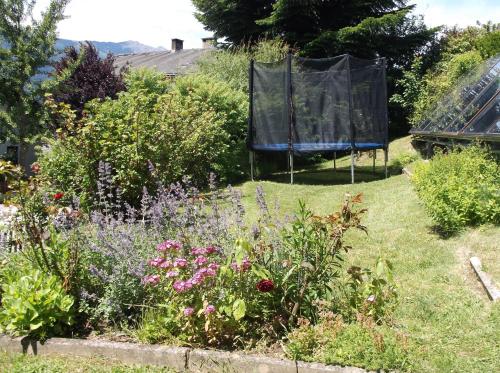 a garden with a black cover and some flowers at Sun Apartments - with Dolomiten Panorama in Lienz
