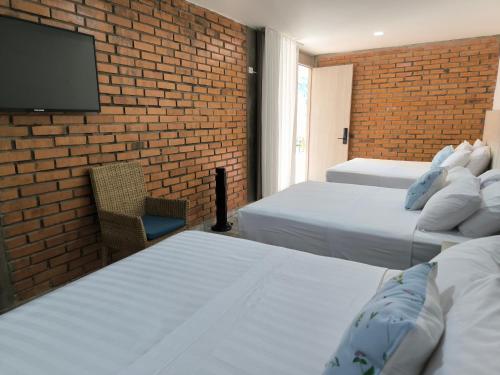 La Colina Balance Hotel tesisinde bir odada yatak veya yataklar