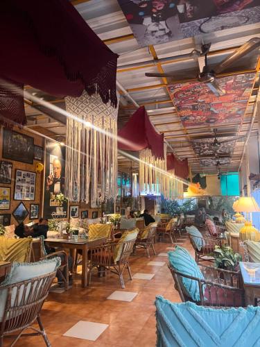 a restaurant with tables and chairs in a room at hotel saina inn in Dehradun