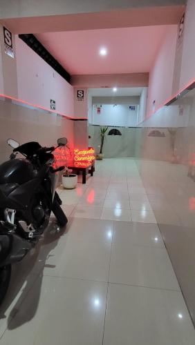 a motorcycle parked in a room with a table at HOSTAL GRAND IBIZA in Huacho