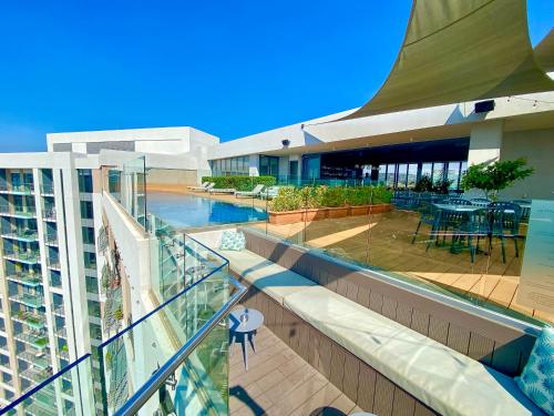 a balcony with a swimming pool and a building at Menlyn Maine Residence Knysna in Pretoria