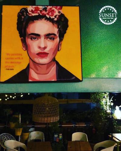 a poster of a man with a flower on his head at hotel saina inn in Dehradun