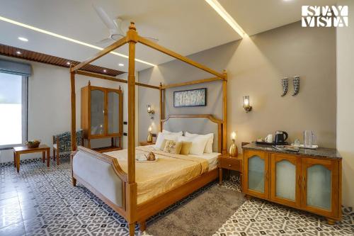 a bedroom with a canopy bed in a room at StayVista at Pandav Greens with Lawn & Bonfire in Pachmarhī