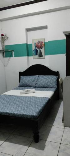 a bedroom with a bed in a room at Center Parkway Pension House in Kalibo