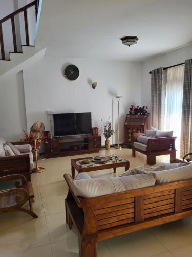 a large living room with couches and a tv at ShaNicky Villa in Kandana