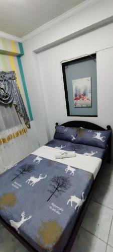a bedroom with two beds with horses on the sheets at Center Parkway Pension House in Kalibo