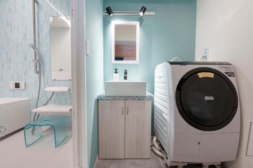 a bathroom with a washing machine and a sink at UMInoTERRACE in Minamiboso