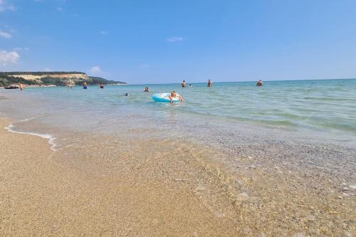 a group of people in the water at a beach at Apartment Oasis A4 Kamchia in Bliznatsi