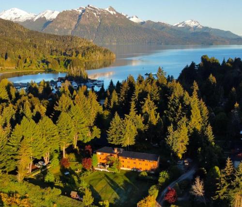 an aerial view of a house next to a lake at Le Bouquet Apart Hotel in San Carlos de Bariloche
