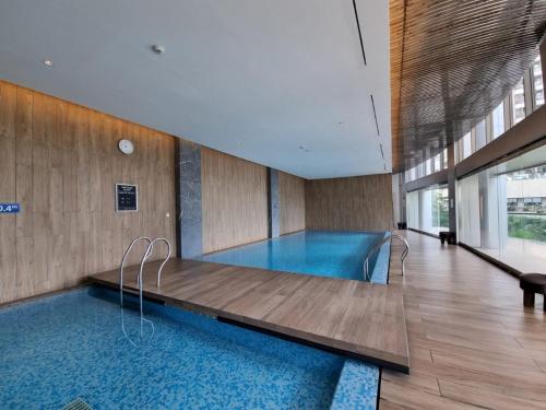 a large swimming pool in a building with a pool at Gin Residence in Jakarta
