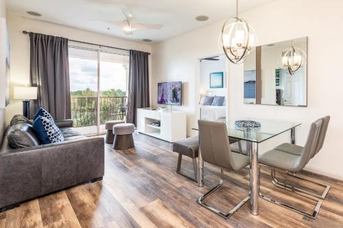 a living room with a glass table and a couch at Pool*Top Floor*Forest Views*Balcony*VistaCay in Orlando