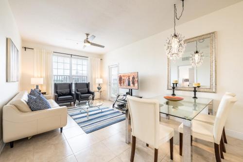 a living room with a glass table and chairs at Top Floor*Balcony*VistaCay Convention Ctr & Idrive in Orlando