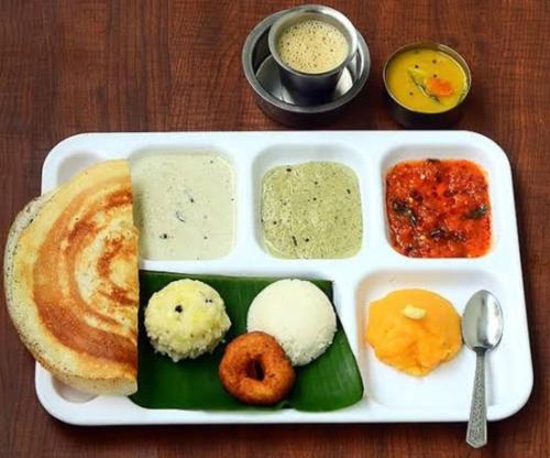 a white tray of food with different types of food at Shriguru Guest House Akkalkot in Akalkot