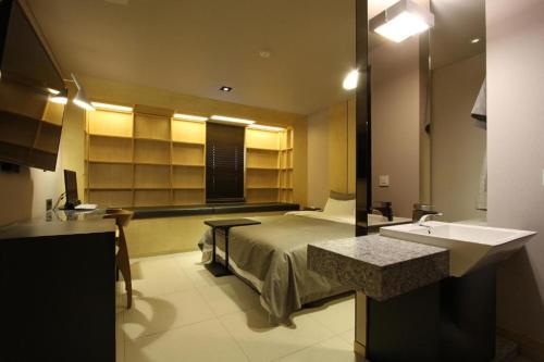 a bathroom with a bed and a sink in a room at Boutique Hotel K-Oido in Siheung