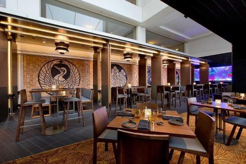 a restaurant with tables and chairs and a brick wall at Casino Residences 1 & 2 Bedroom Apartments in Gold Coast
