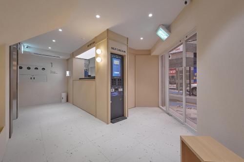 an empty hallway of a building with a vending machine at Maison de Centum Busan in Busan