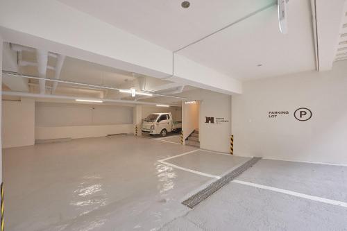 an empty garage with a van parked in it at Maison de Centum Busan in Busan